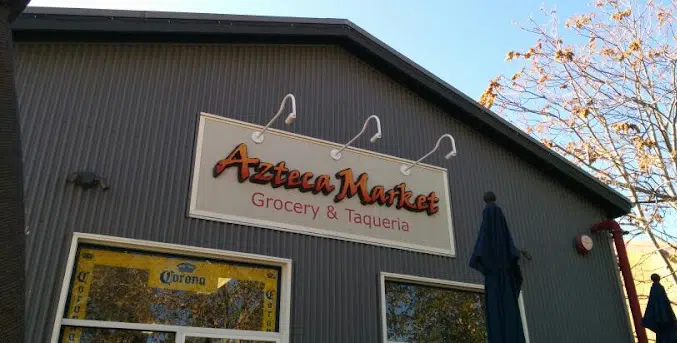 A building with a sign that says Azteca Market Grocery & Taqueria